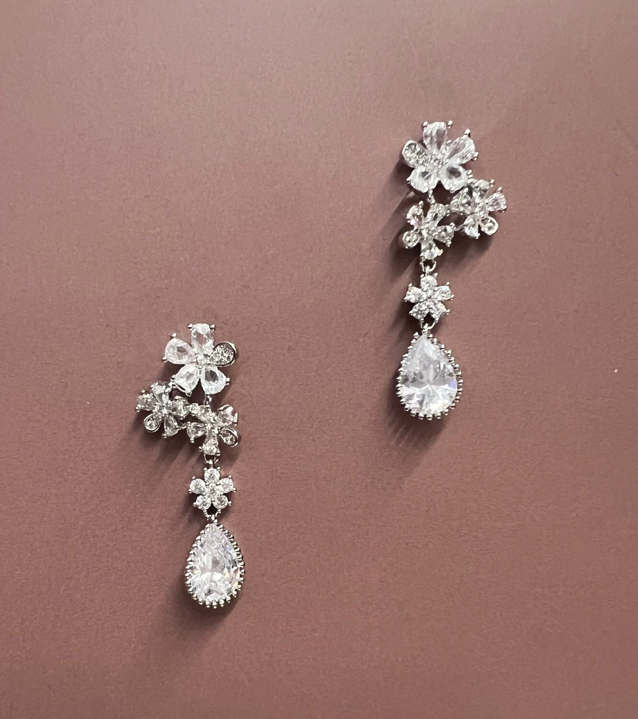 Silver Calla Collection earrings with elegant floral design, showcasing intricate craftsmanship and shiny finish.