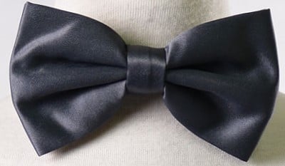 Boy wearing a stylish black bowtie from the Calla Collection Boys BOWTIE-MAN-MORE collection.