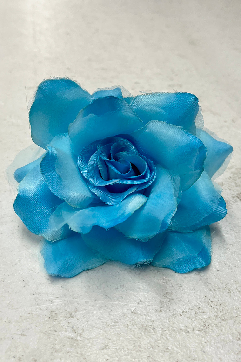 Colorful fabric faux flowers from Kid's Dream accessories set, featuring aqua and mixed shades for craft or decor projects.