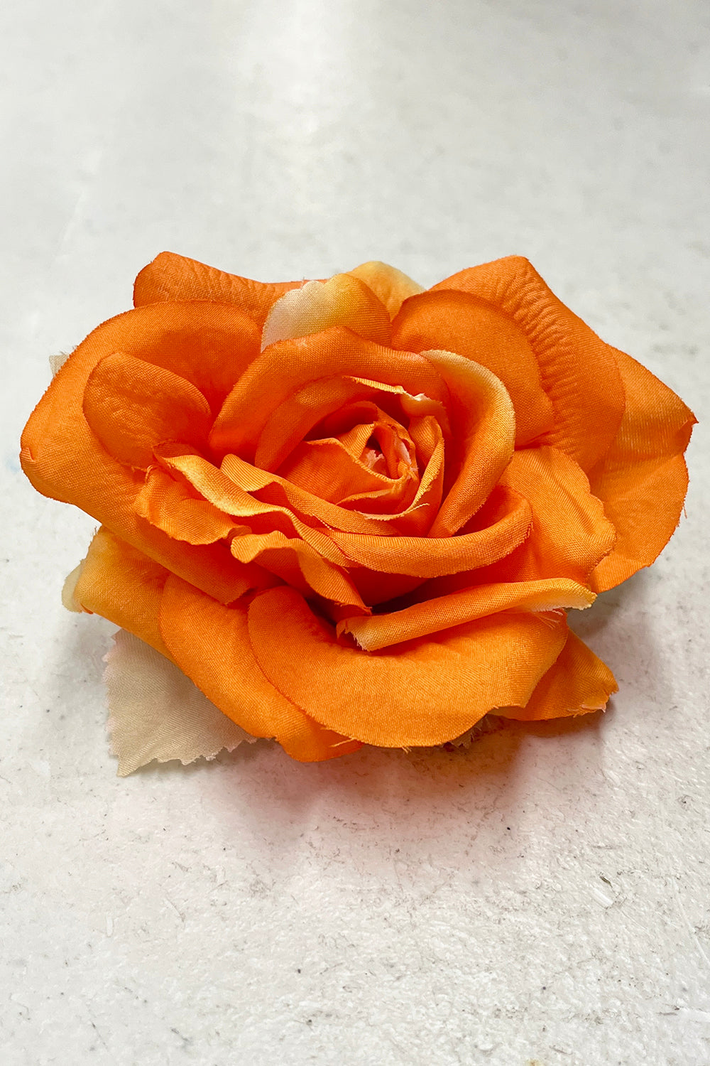 Assorted fabric faux flowers in orange, used as accessories, from Kid's Dream, displayed in single or pack options.