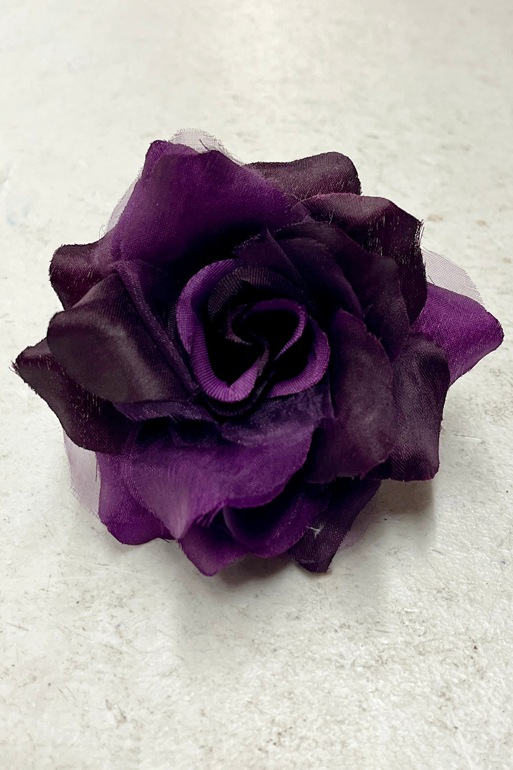 Purple fabric faux flower accessories by Kid's Dream, featuring a variety of single and pack floral decorative pieces.