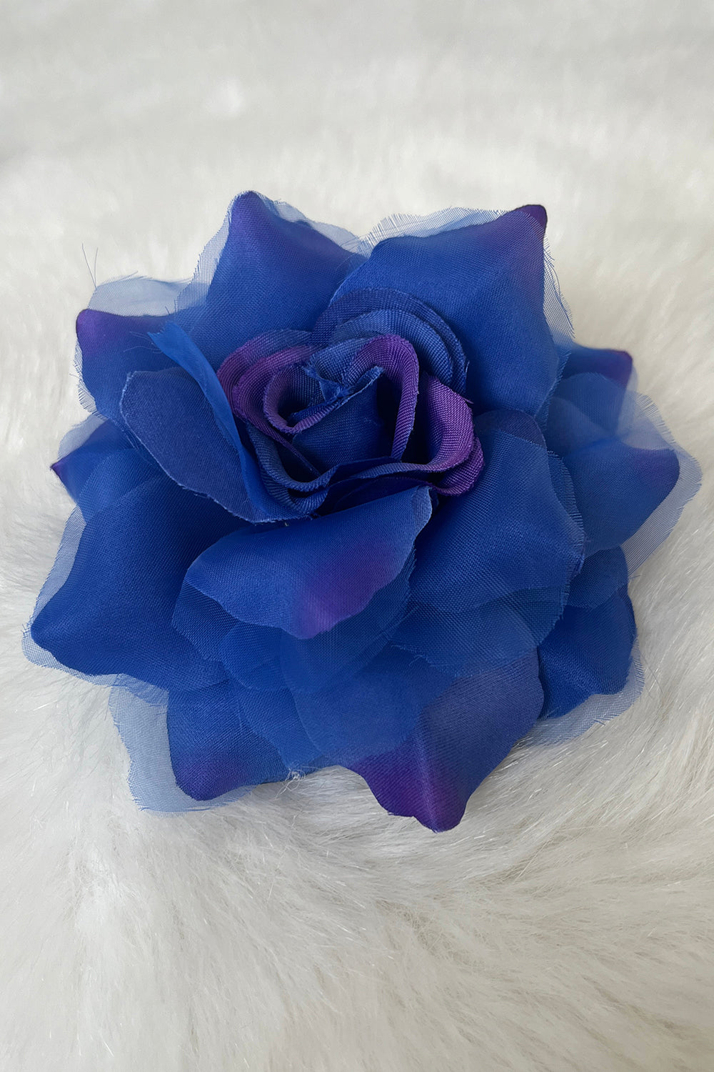 Assorted fabric faux flowers in royal blue, pink, and purple, used as accessories from Kid's Dream.