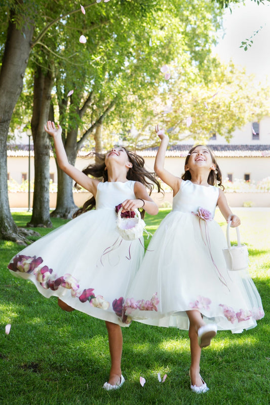 White satin flower petal girl dress by Kid's Dream, featuring delicate floral details and a soft, elegant design for special occasions.