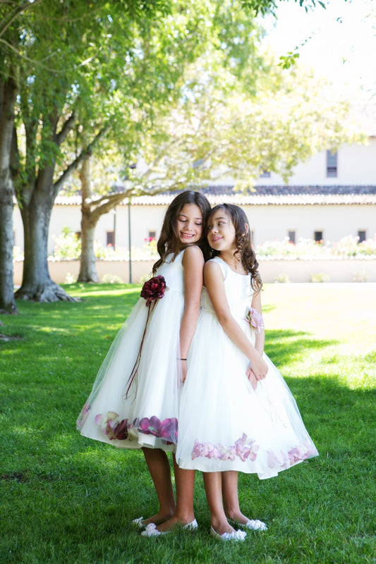 White satin flower petal girl dress by Kid's Dream, featuring delicate floral details and a flowing satin skirt for special occasions.