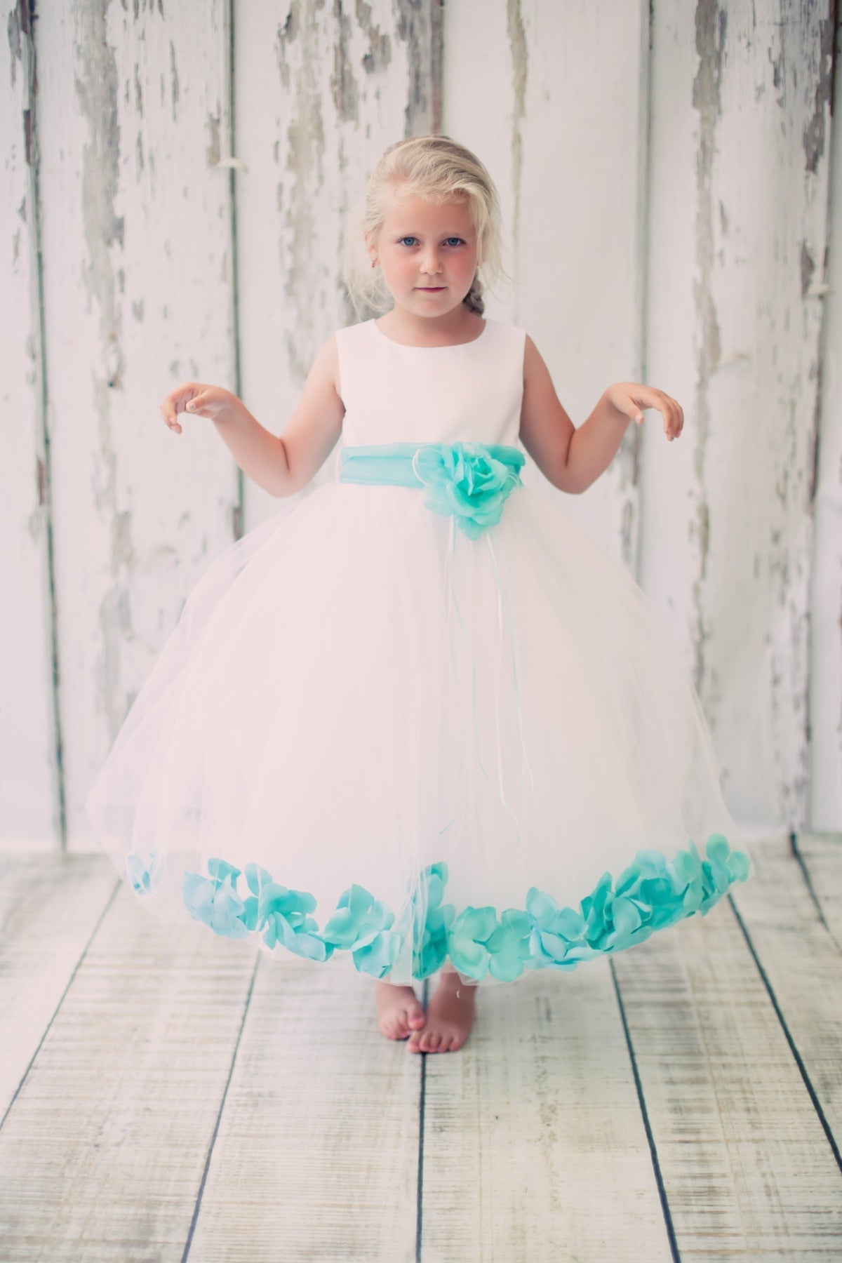 White satin flower petal girl dress with organza sash by Kid's Dream, showing the elegant dress with floral details and sash.