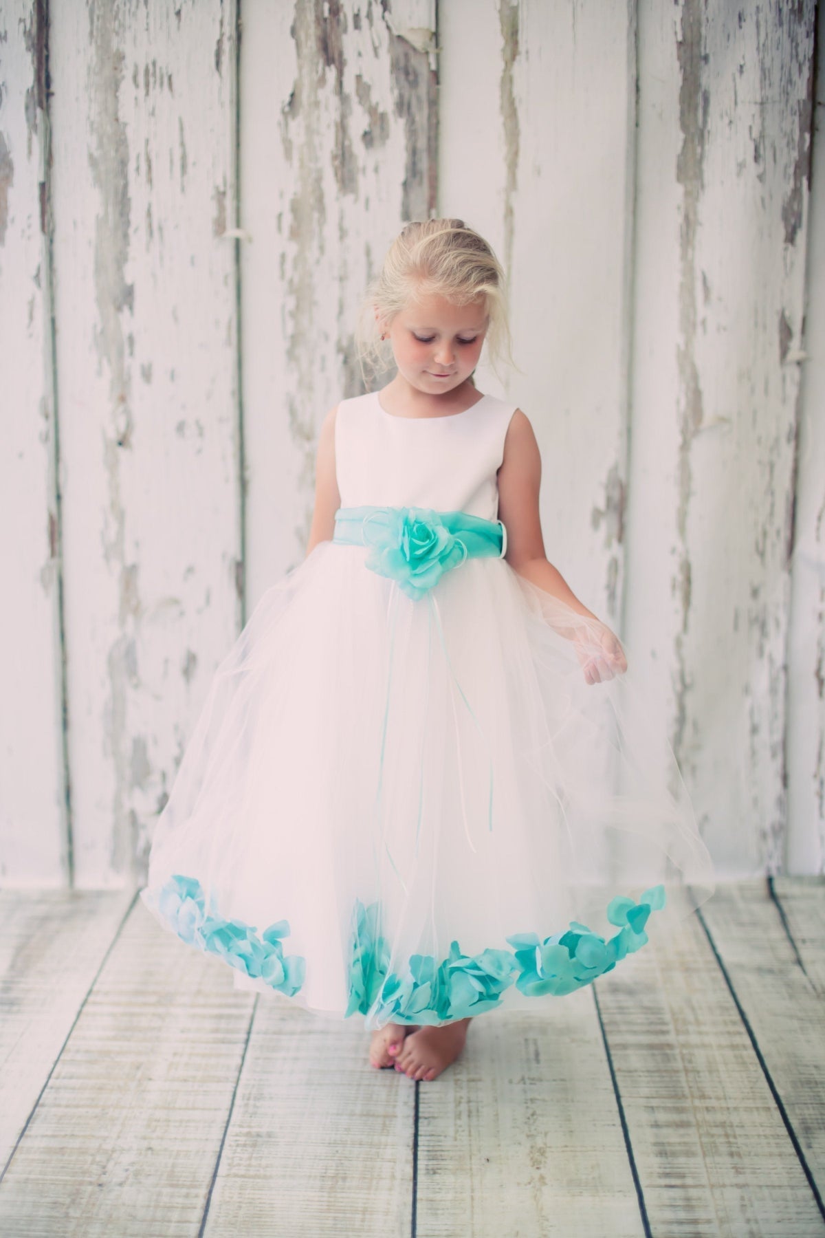 White satin flower petal girl dress with organza sash, by Kid's Dream, featuring a delicate design and elegant fabric details.