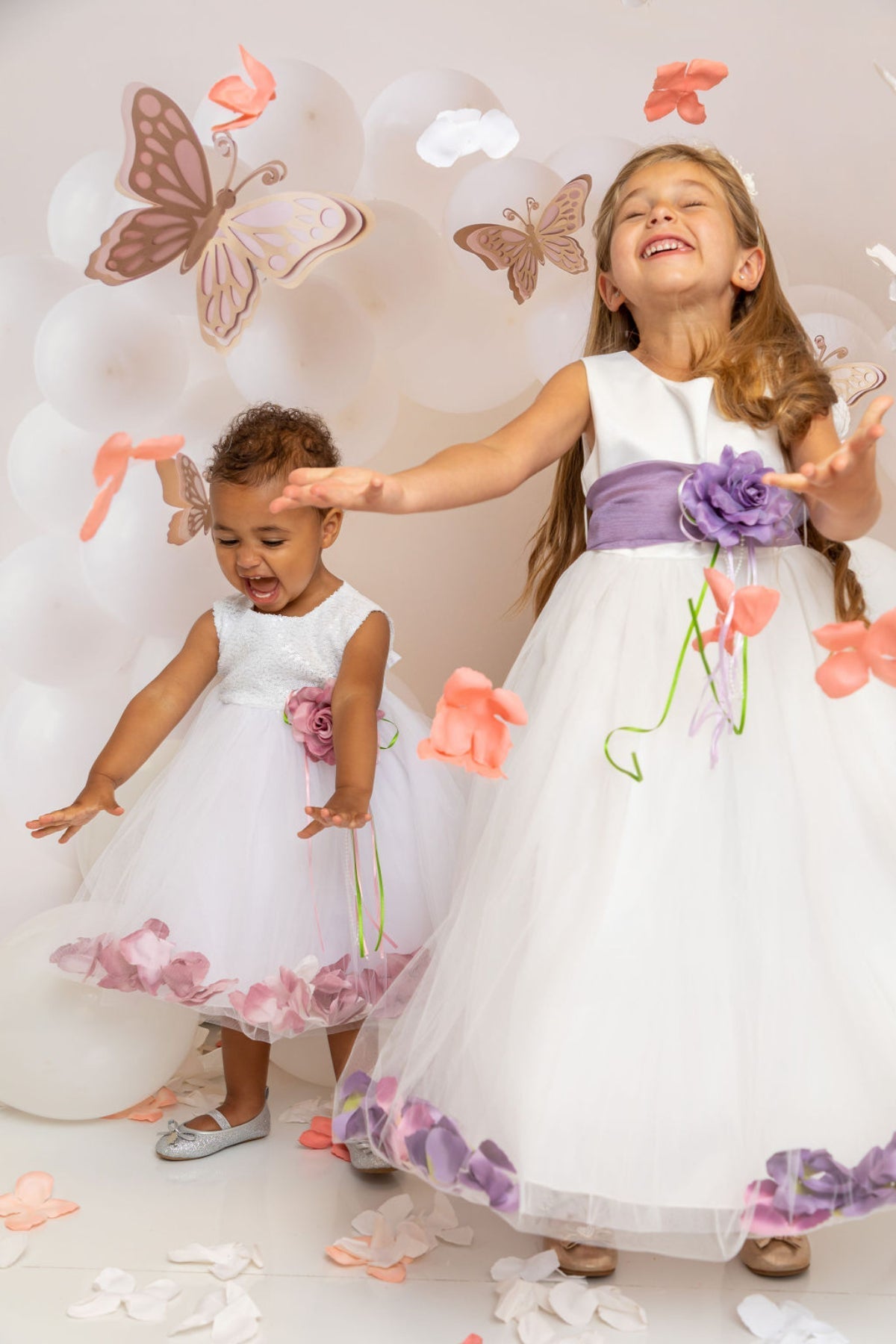 White satin girl dress with organza sash and flower petal details, designed for kids by Kid's Dream.