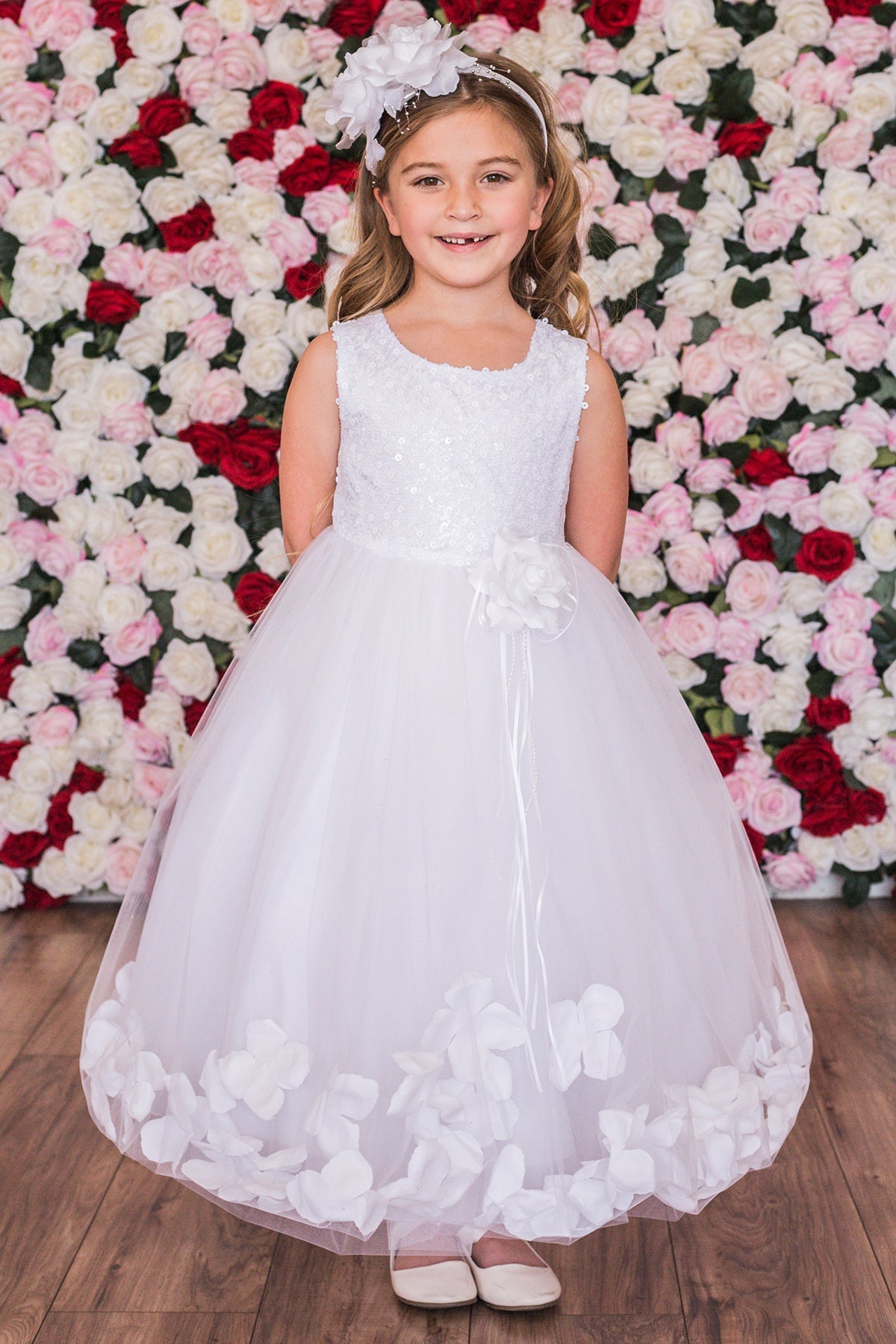 White sequin top flower petal girls' dress by Kid's Dream featuring a sparkly sequined bodice and floral petal skirt.
