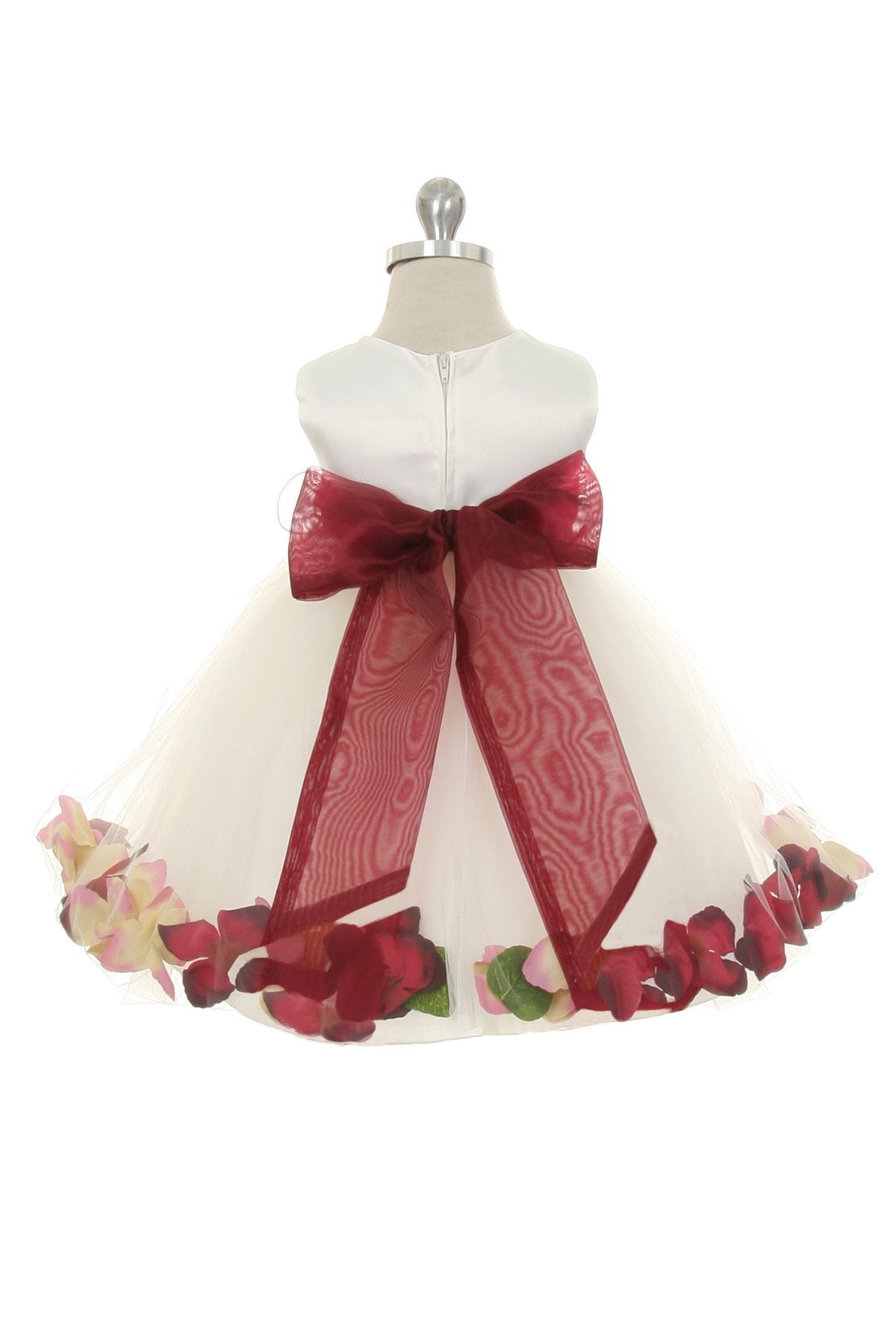 White satin baby dress with flower petal design and organza sash by Kid's Dream, showing the front view with ruffled details.