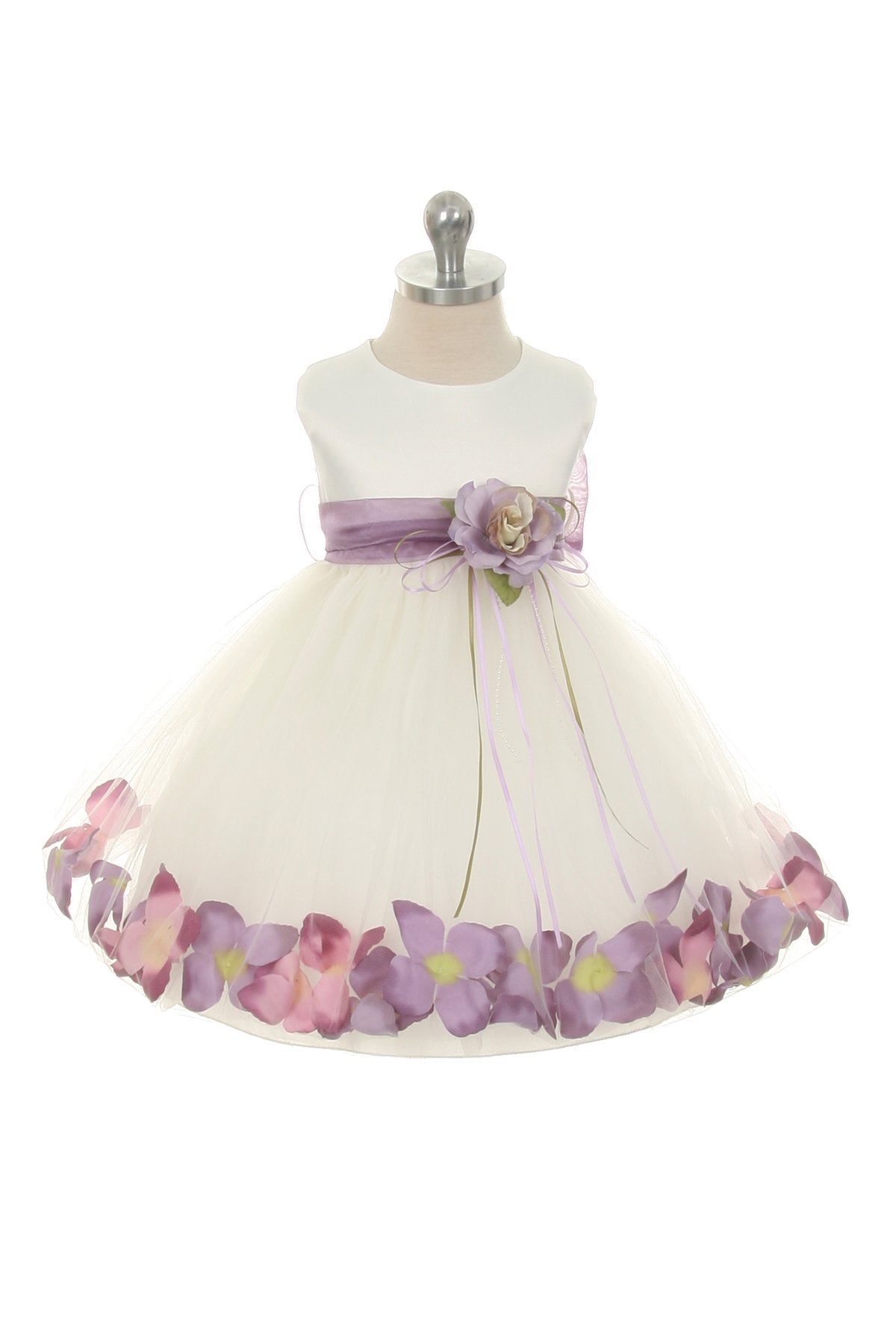 White satin baby dress with flower petal design, organza sash, by Kid's Dream, featuring lavender accents and delicate floral details.