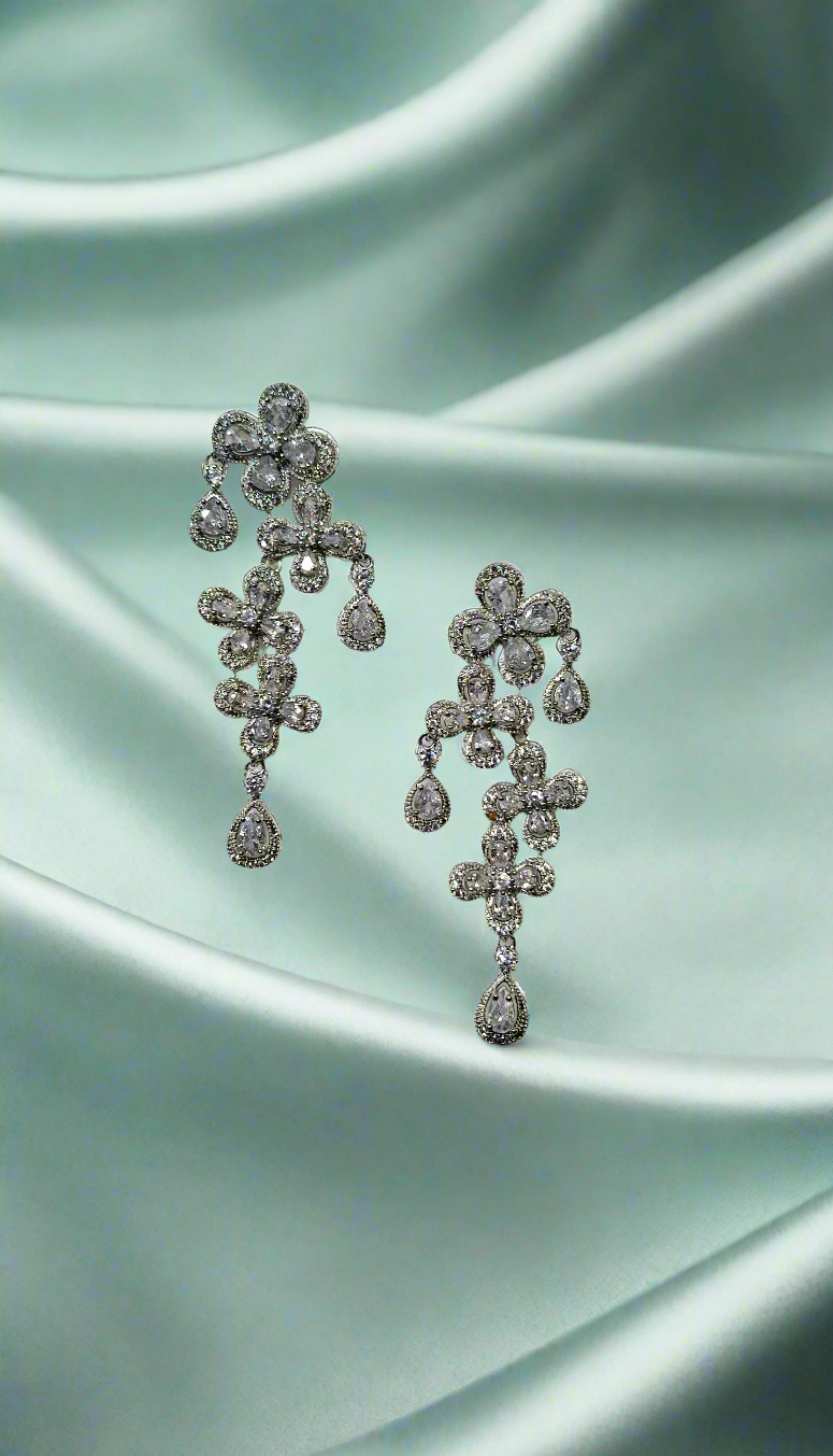 Elegant Calla Collection earrings with intricate silver design, shown close-up against a neutral background.