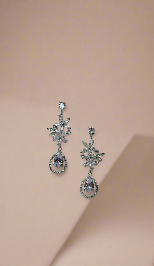 Elegant CALLAcollection earrings featuring intricate silver design with gemstone accents, displayed on a neutral background.