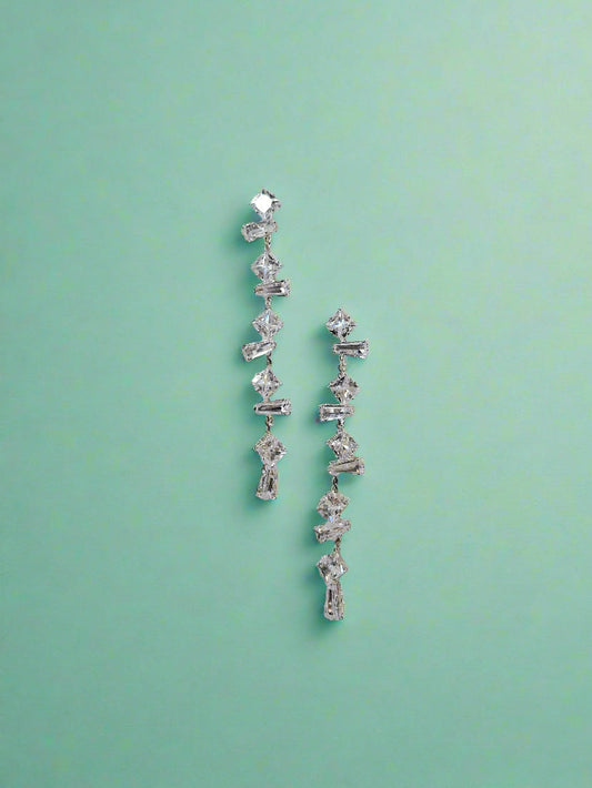 Elegant silver CALLAcollection earrings with intricate floral design, showcasing detailed craftsmanship and shiny finish.