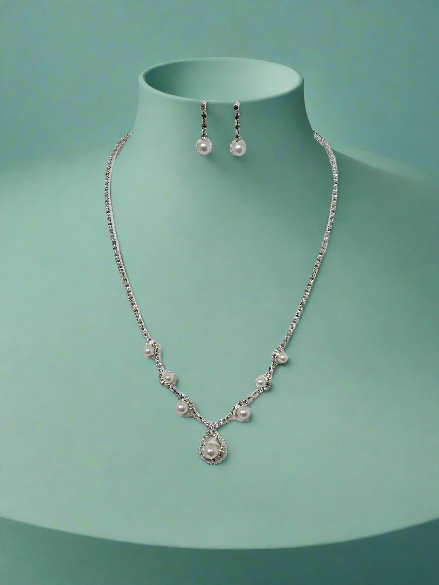 Calla Collection necklace with delicate chain and pendant, featuring elegant jewelry design on a neutral background.
