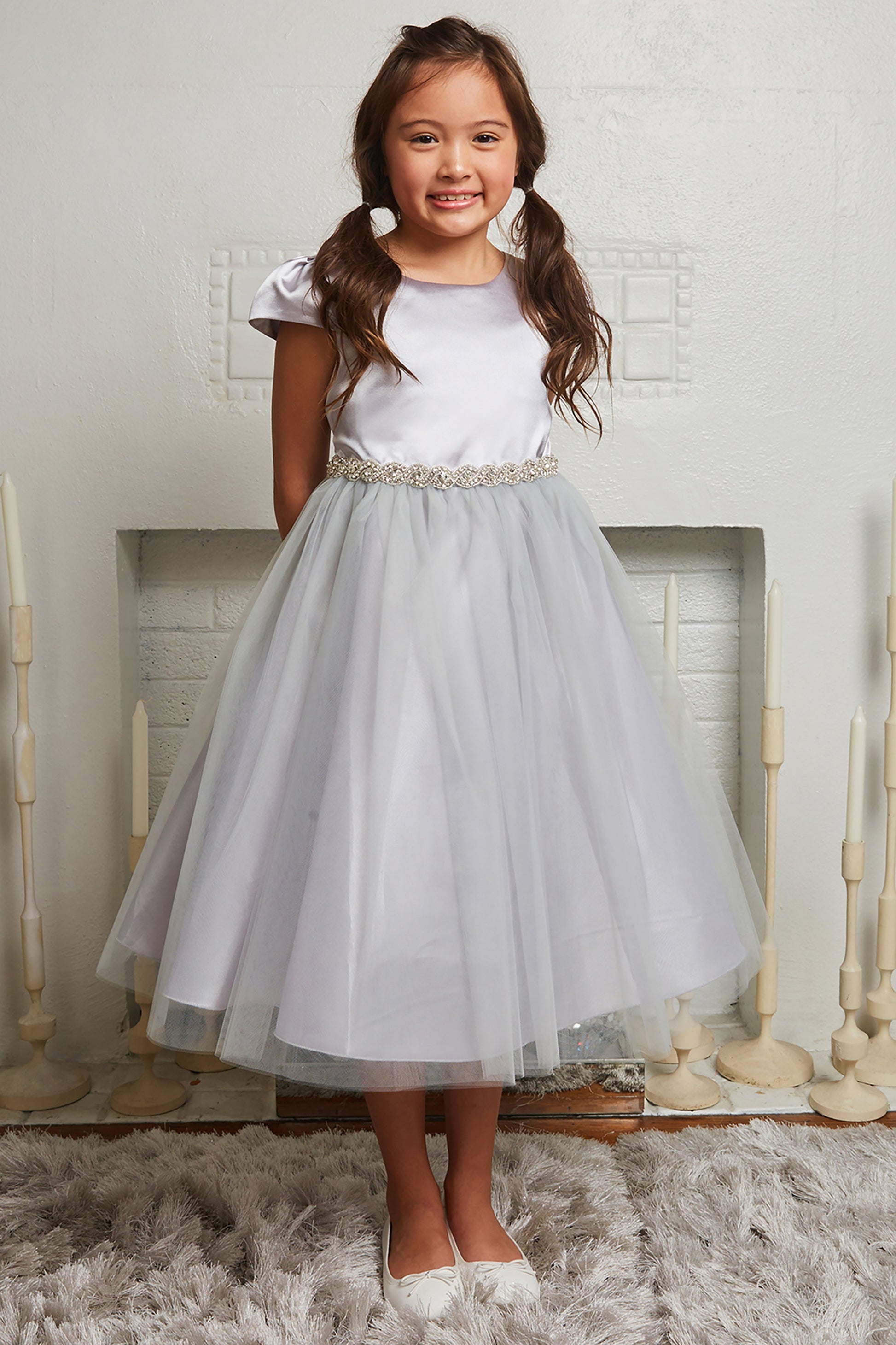 Plus size satin and tulle dress with capped sleeves and braided rhinestone trim, designed for elegant occasions.