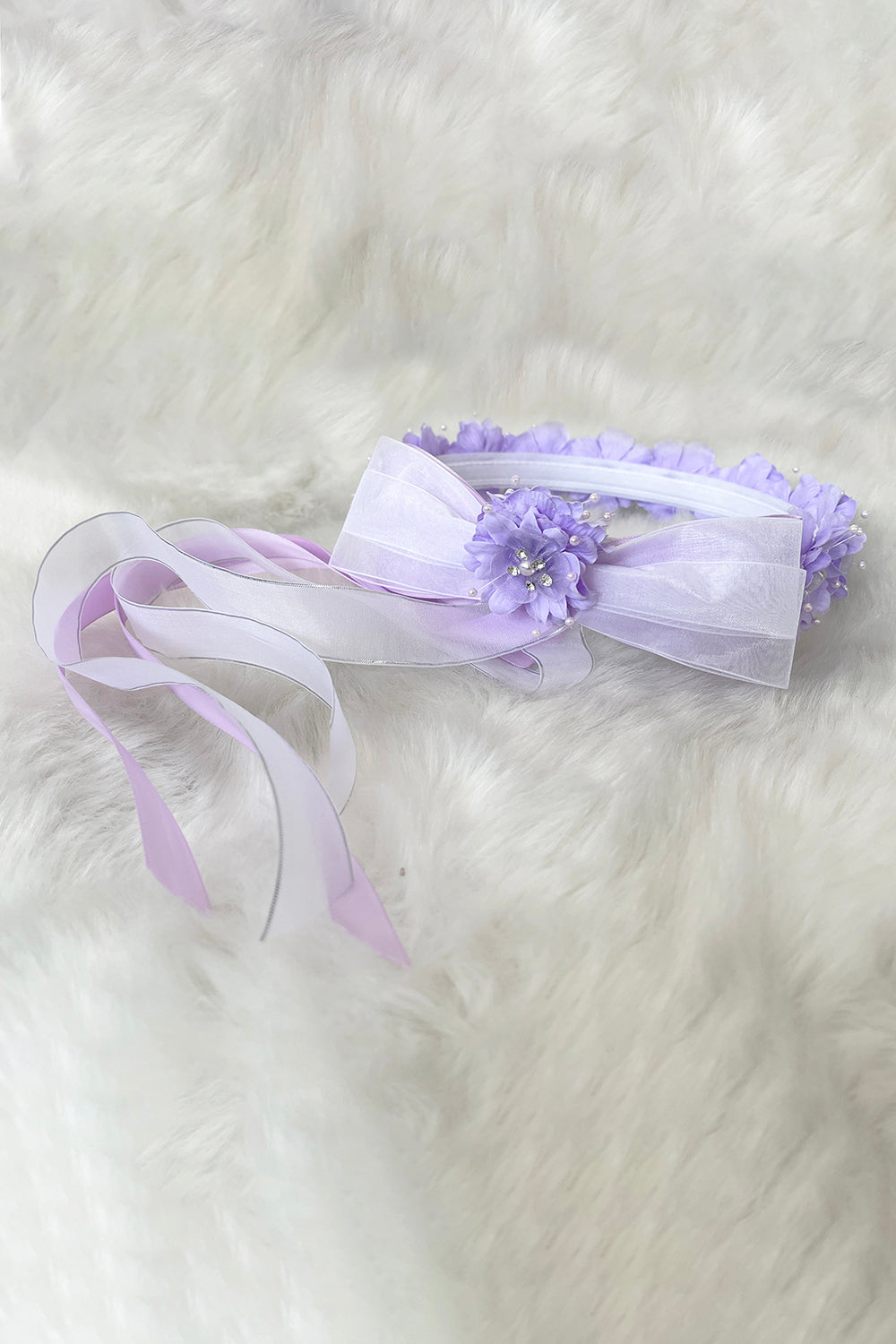 Lilac flower crown with gems and ribbons for kids, featuring colorful blooms and sparkling accents, by Kid's Dream.
