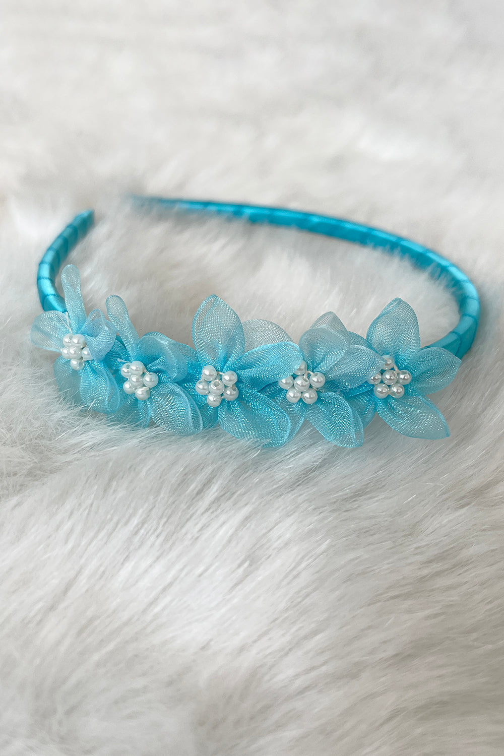Aqua organza flower headband with pearl detailing for kids, featuring delicate fabric flowers and elegant pearl accents.