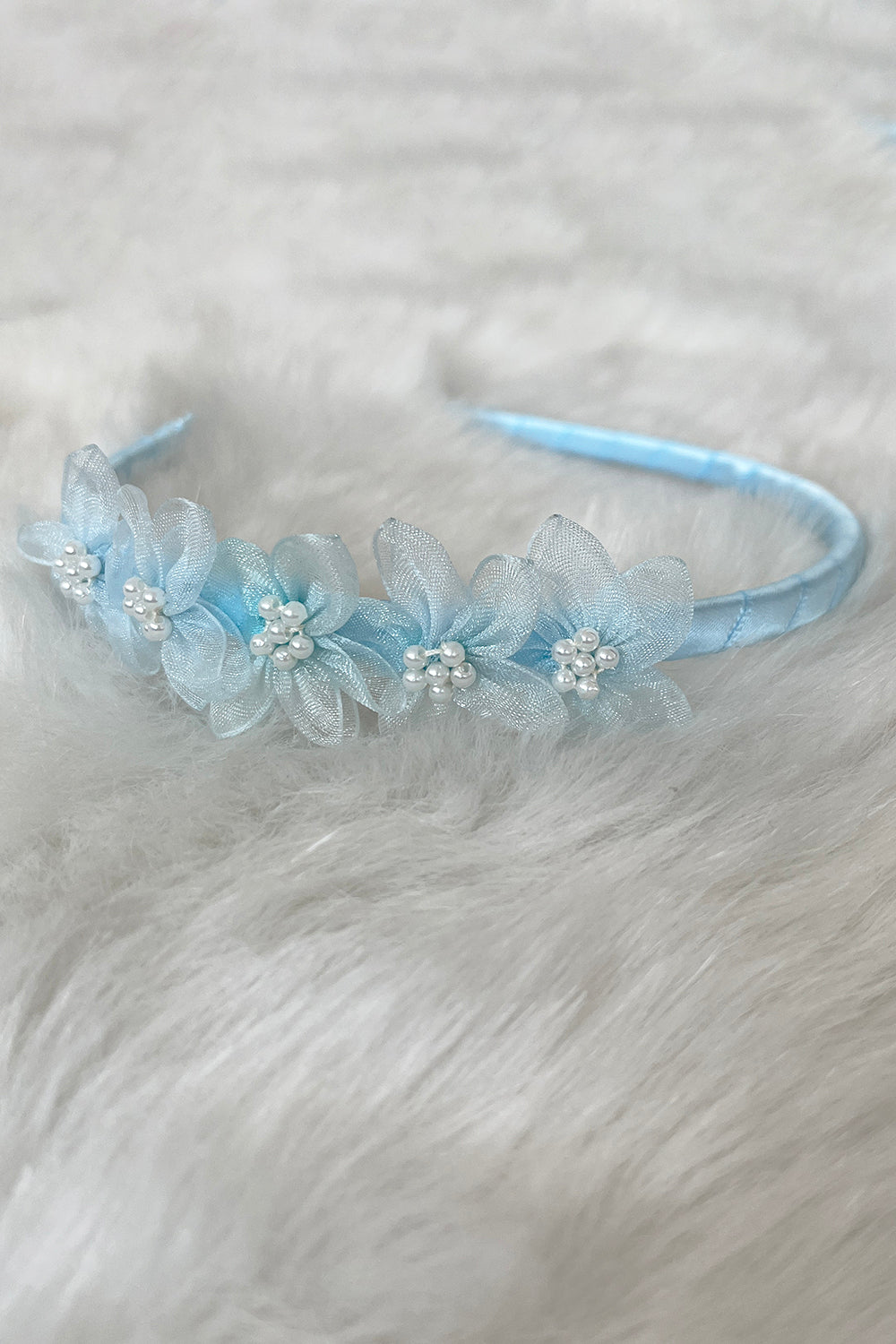 Baby blue organza flower headband with pearl detailing, children's accessories from Kid's Dream featuring delicate fabric flowers.