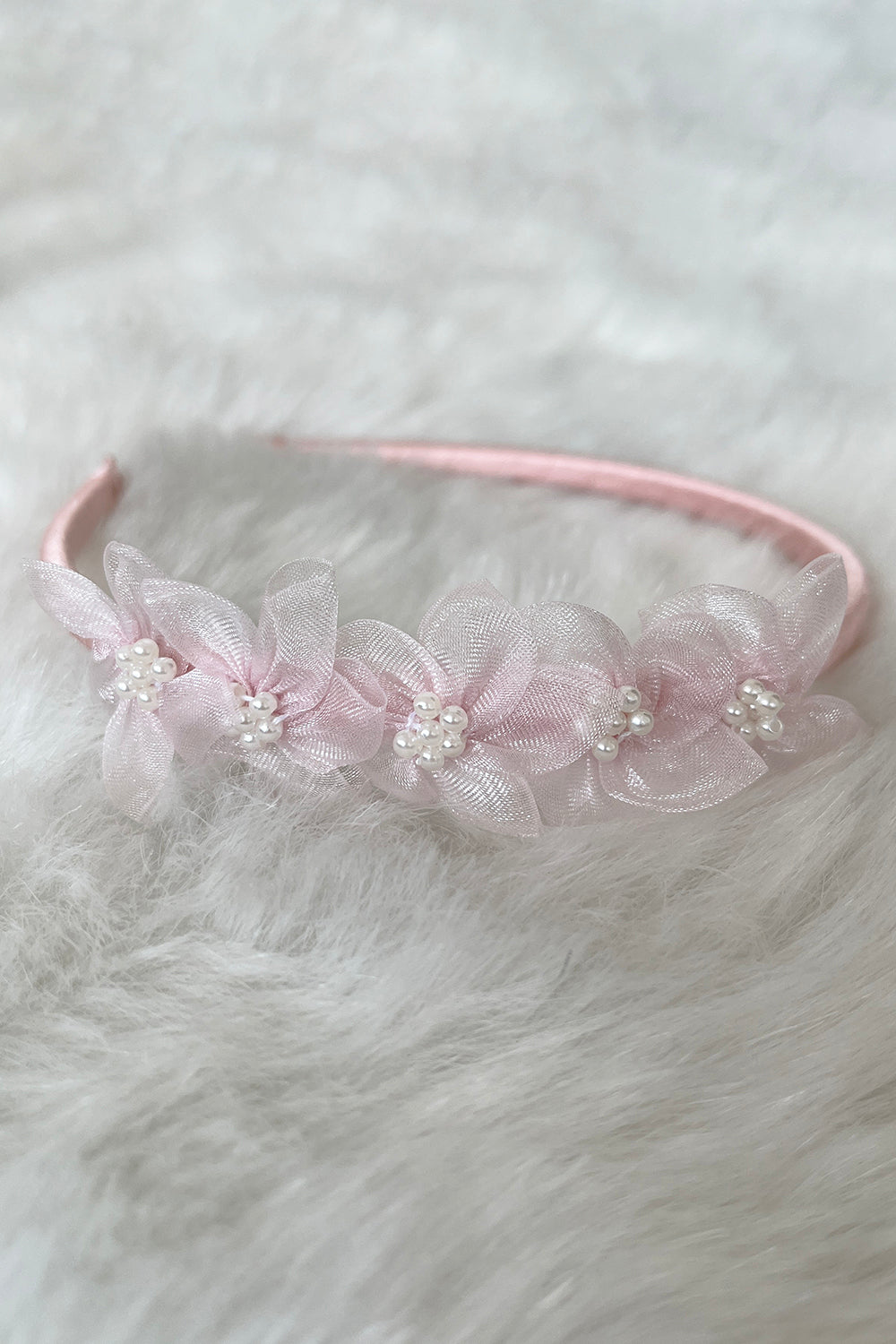 Blush organza flower headband with pearl accents for kids' accessories, featuring delicate satin and pearl detailing.