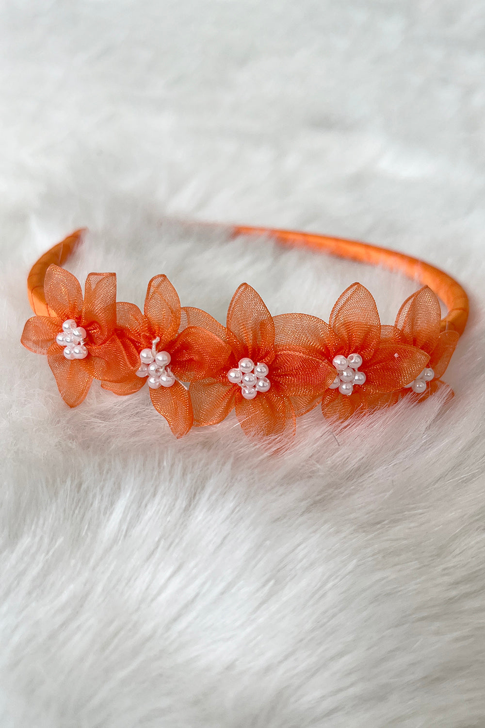 Kid's Dream orange organza flower headband with pearl detailing, a delicate and stylish accessories piece for children.