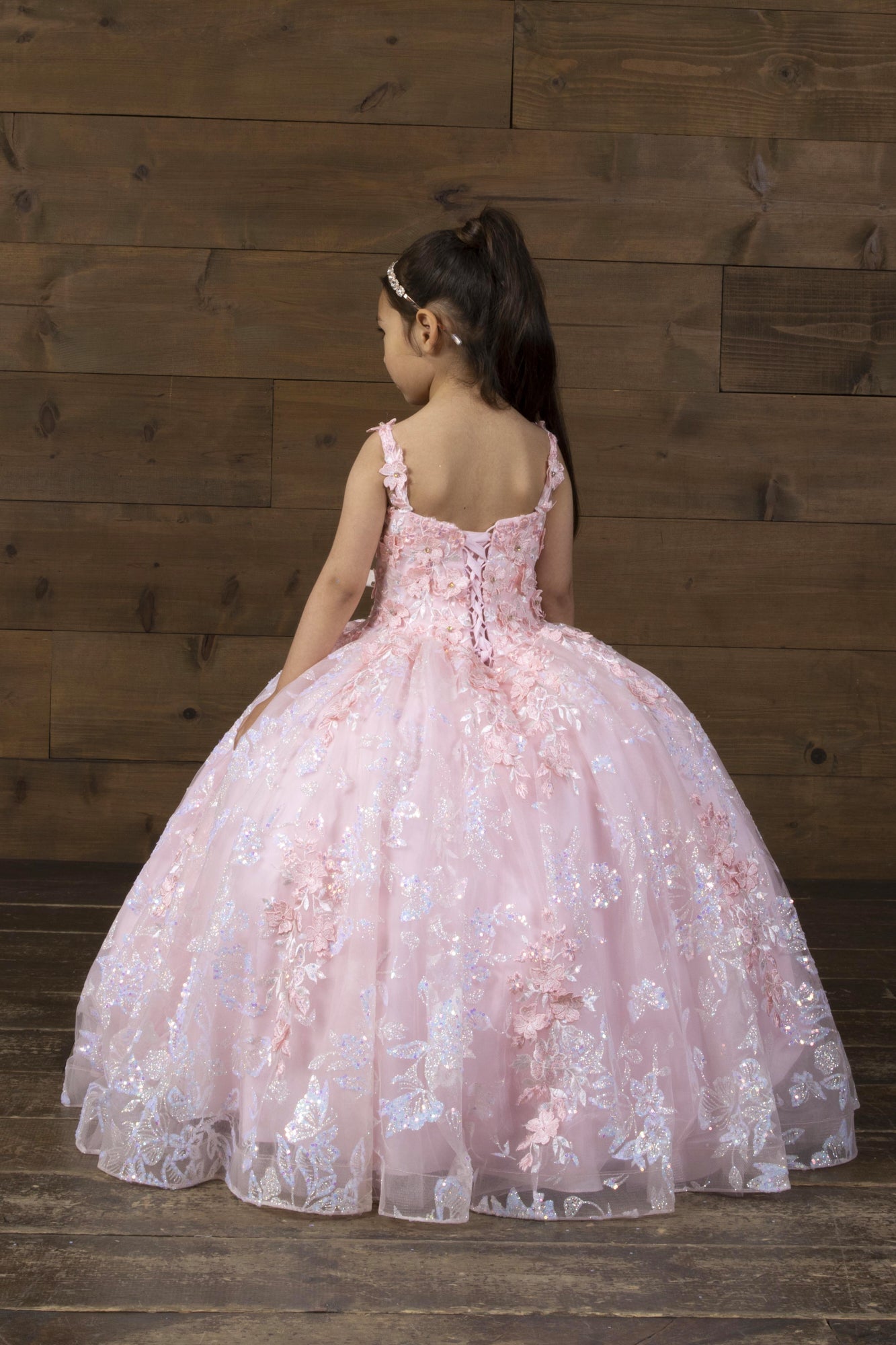 Profile view of the structured natural waistline transitioning into cascading mesh layers on the Calla Collection SCK-323 youth gown.