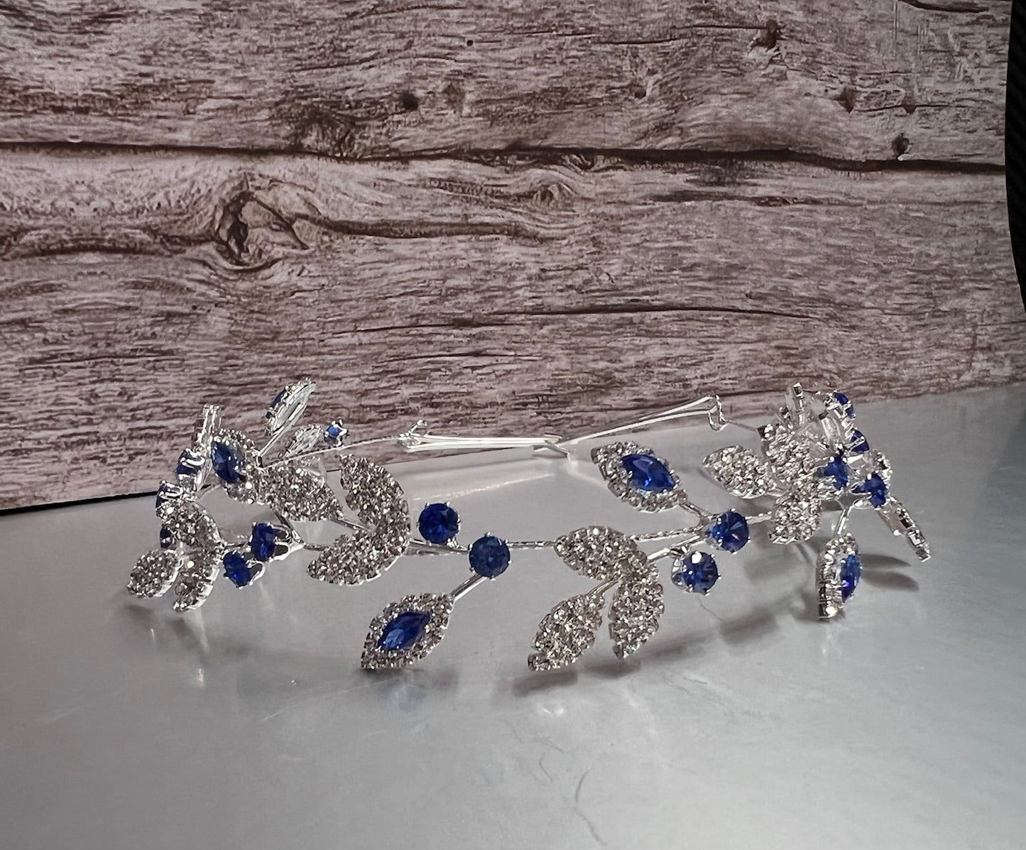 Royal blue jewelry piece from Calla Collection, featuring intricate design and vibrant color in a detailed close-up image.