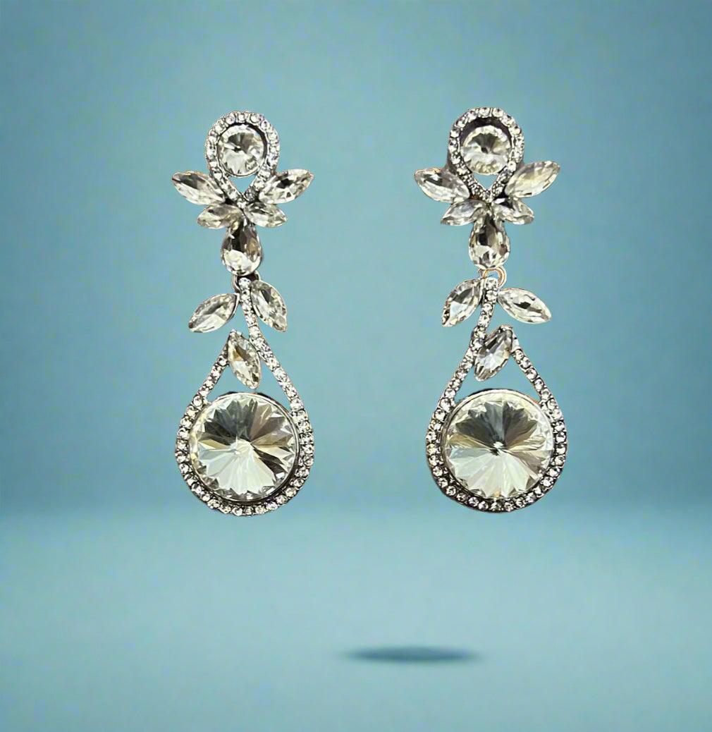 Silver Calla Collection earrings with large dangling rhinestones, showcasing elegant, sparkling jewelry design.