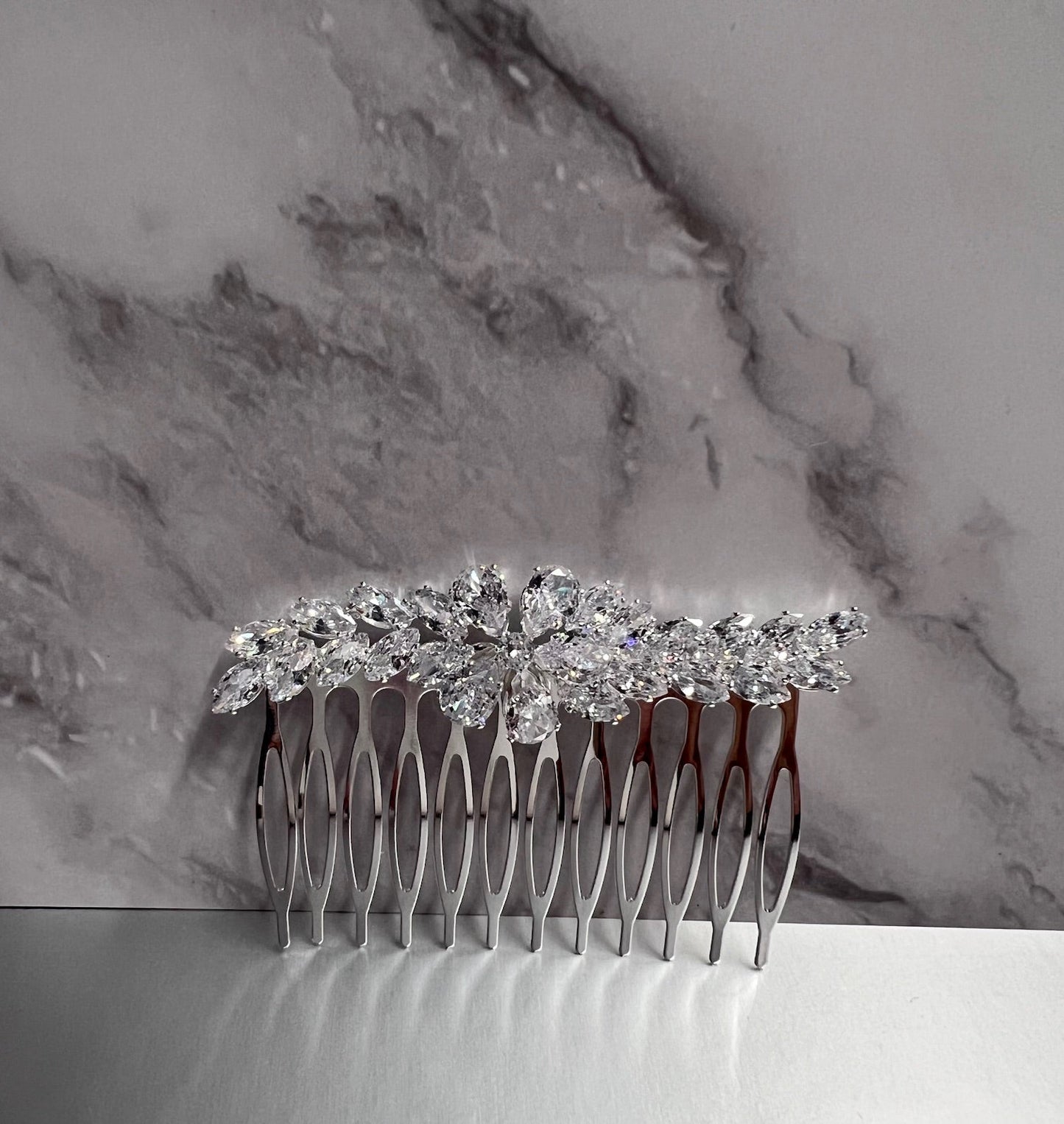 Silver jewelry piece from Calla Collection, featuring intricate design and fine craftsmanship, showcased in the image.