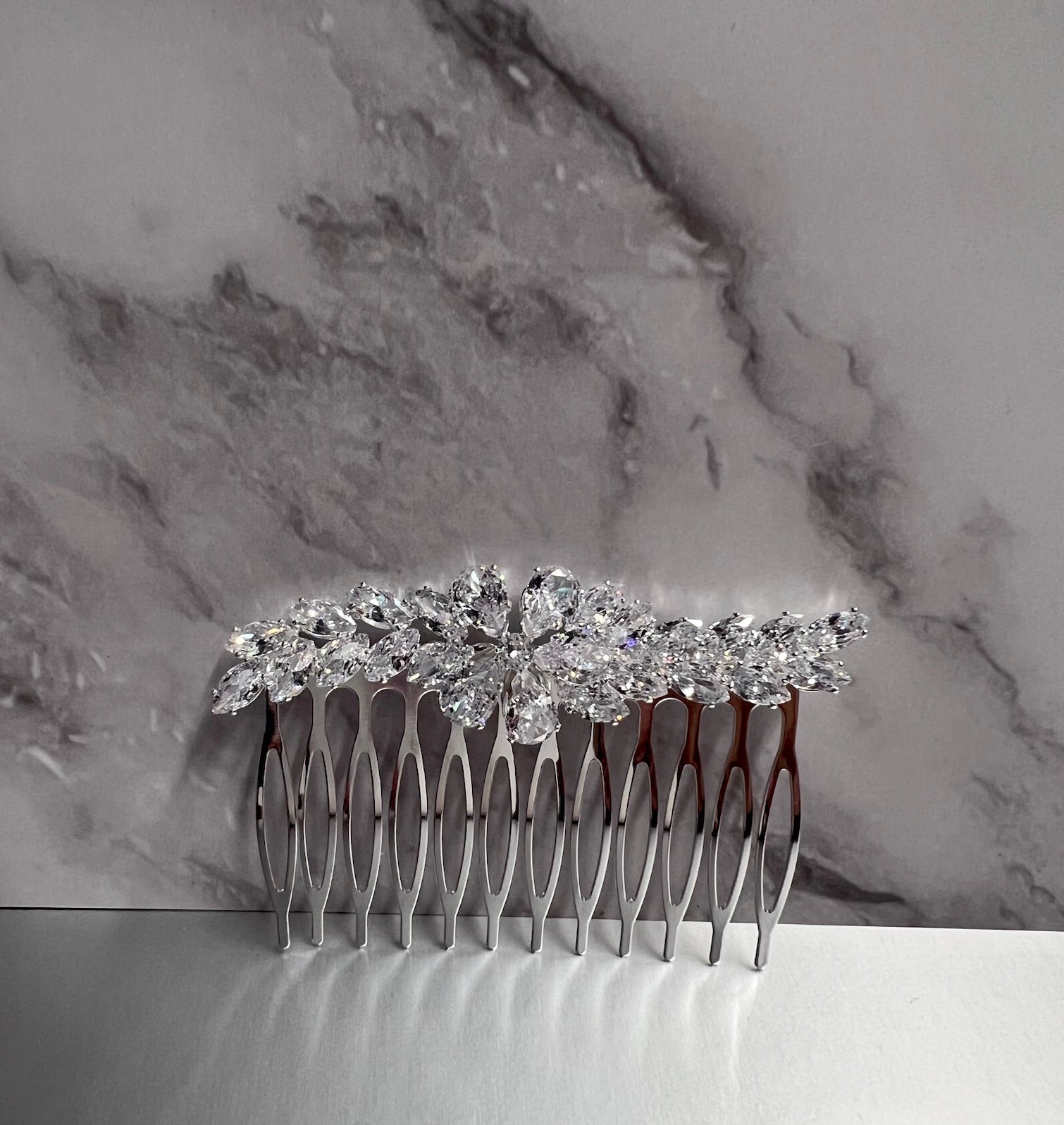 Silver jewelry piece from Calla Collection, featuring intricate design and fine craftsmanship, showcased in the image.