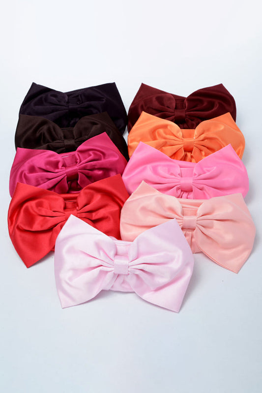 Elegant satin sash accessory in soft pink, featuring smooth fabric and a delicate bow, perfect for special occasions.