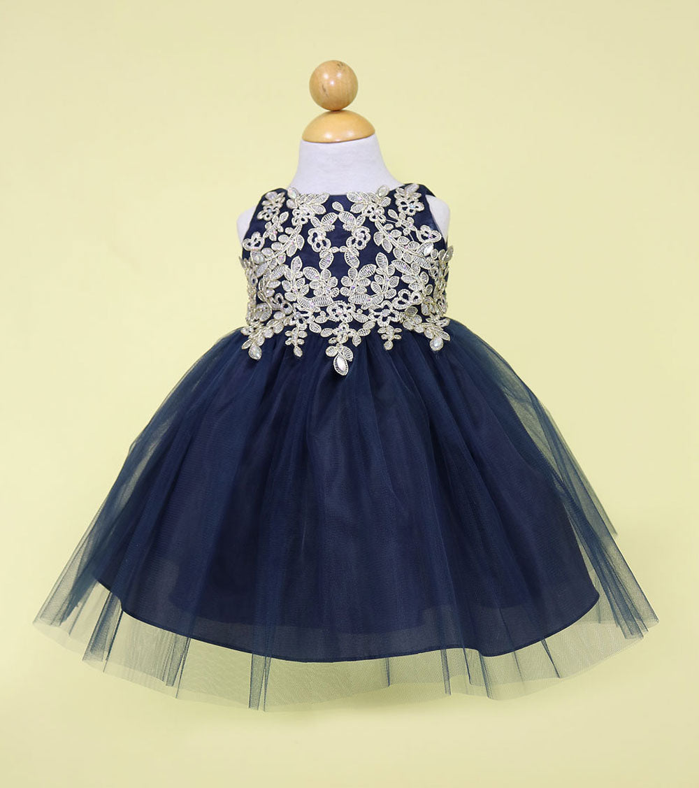 Front view of infant navy blue formal gown featuring metallic gold lace embroidery.
