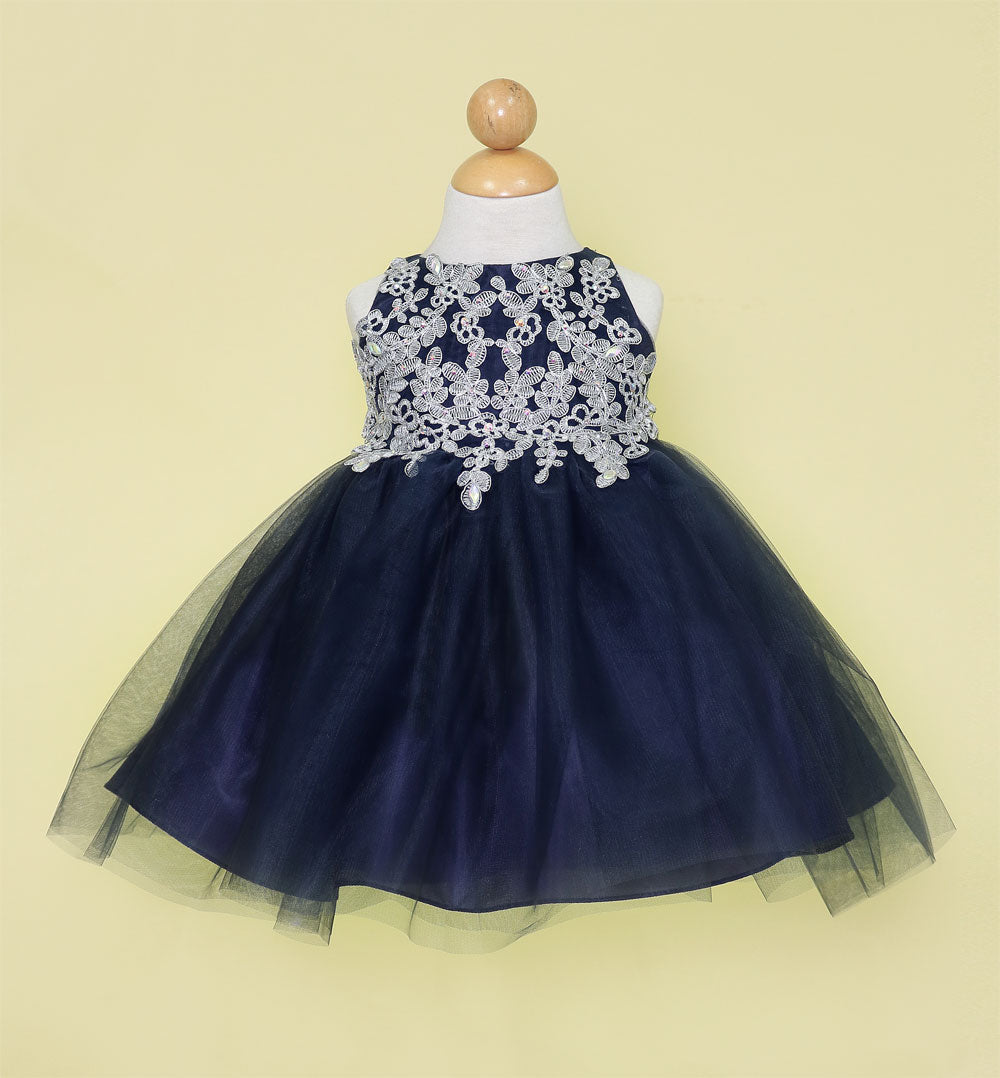 Front view of infant navy blue formal gown featuring metallic silver lace embroidery.